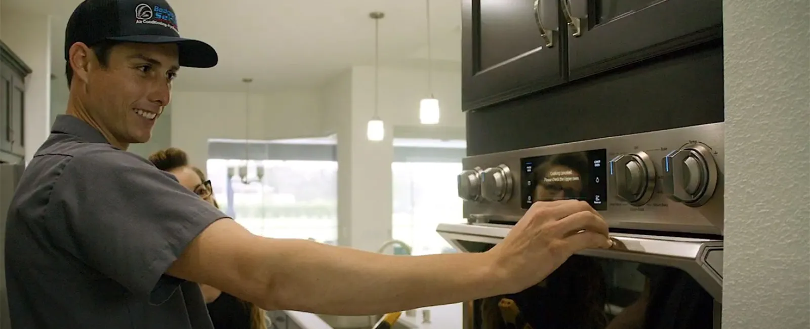 a man in a hat cooking in a kitchen