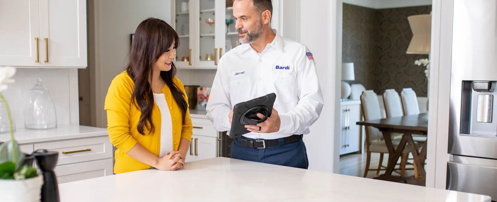 a man and a woman standing in a kitchen