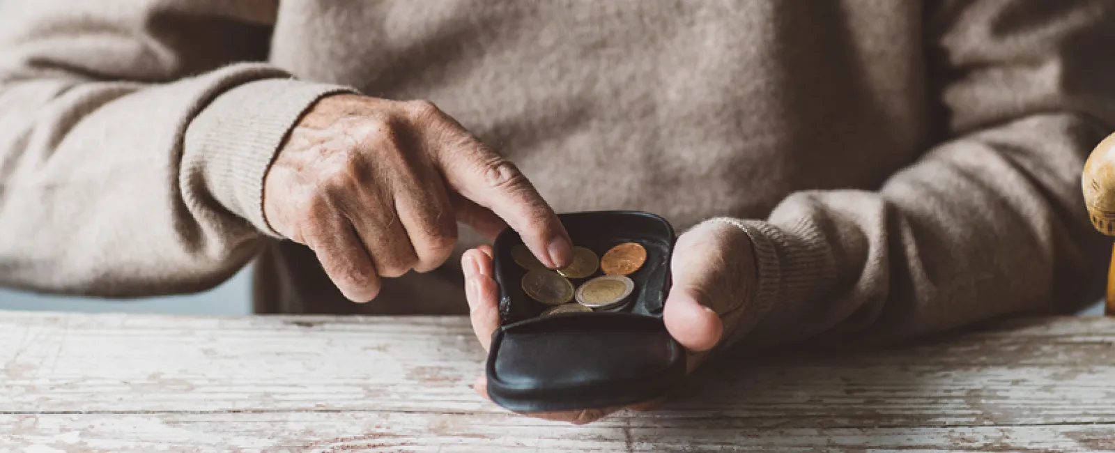 a person holding a black device with coins on it