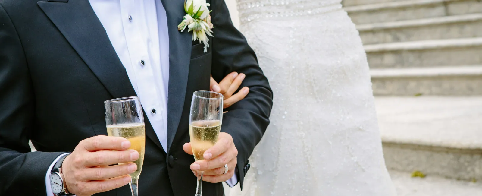 a person in a tuxedo holding a glass of champagne