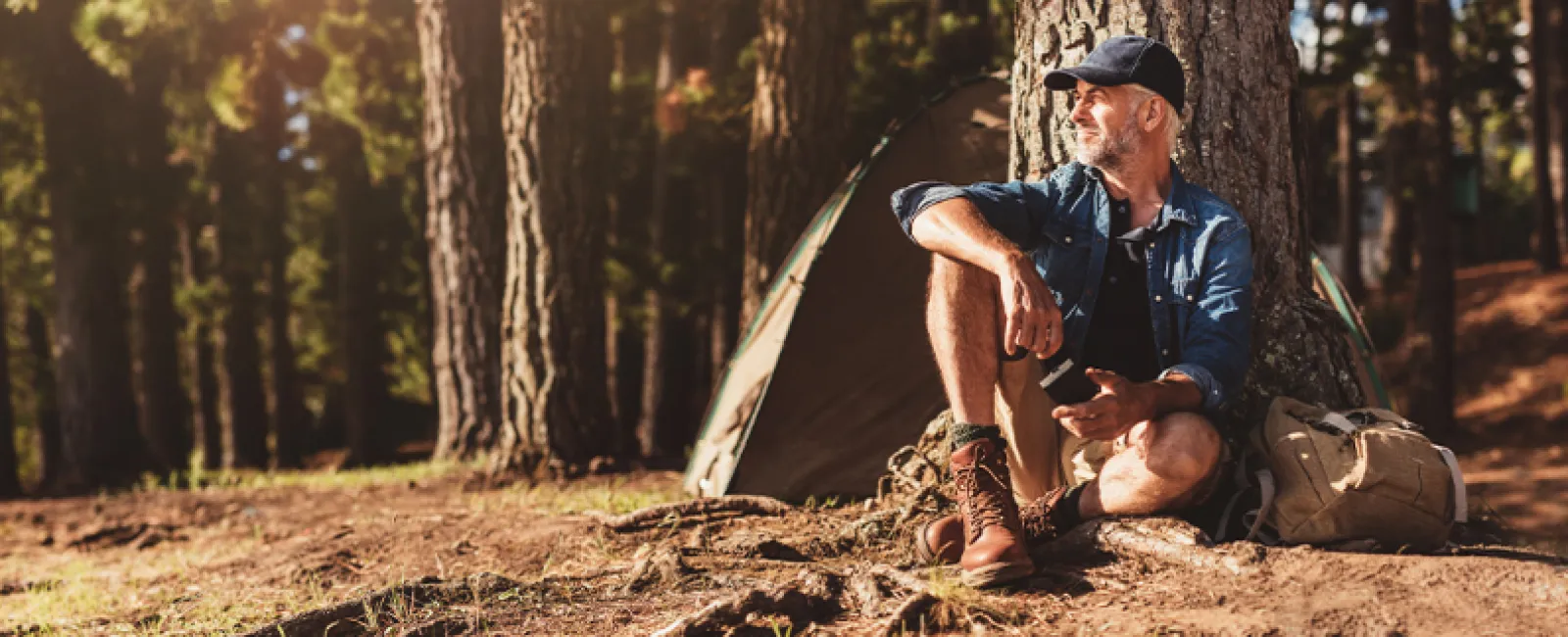 a man sitting in a forest