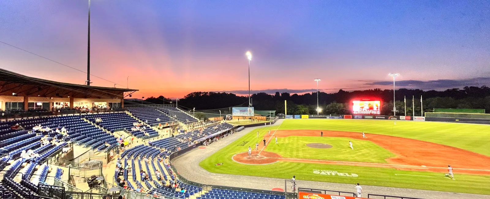 a baseball field with a crowd watching