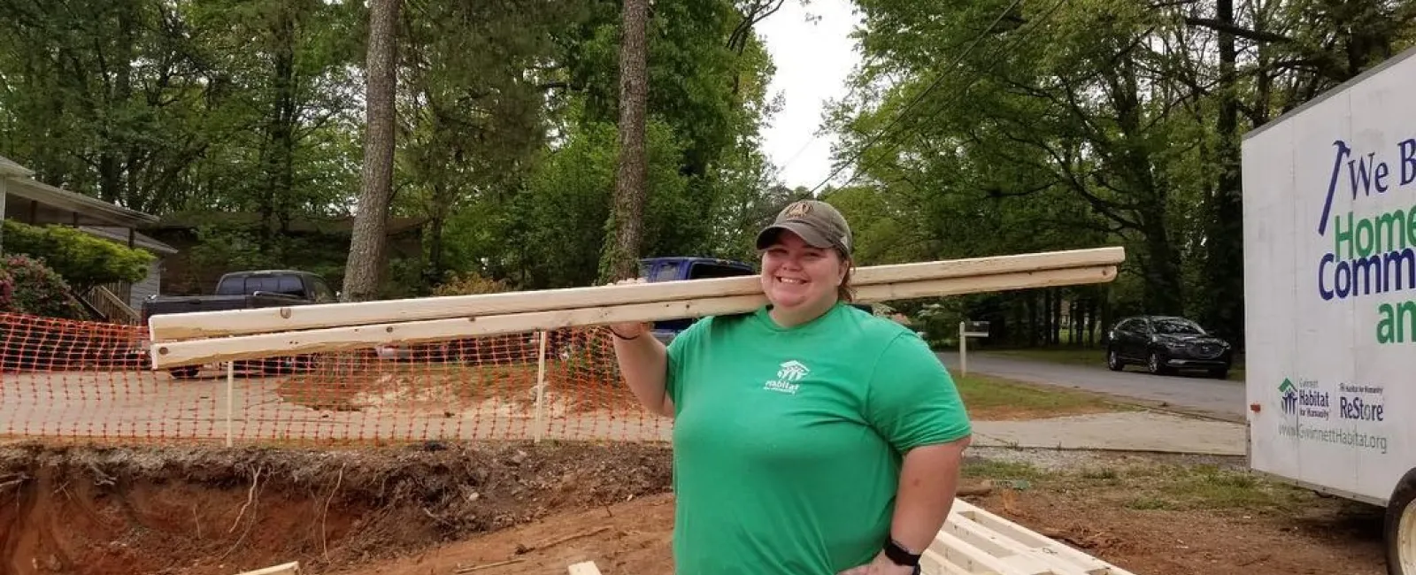 a person standing next to a wood structure