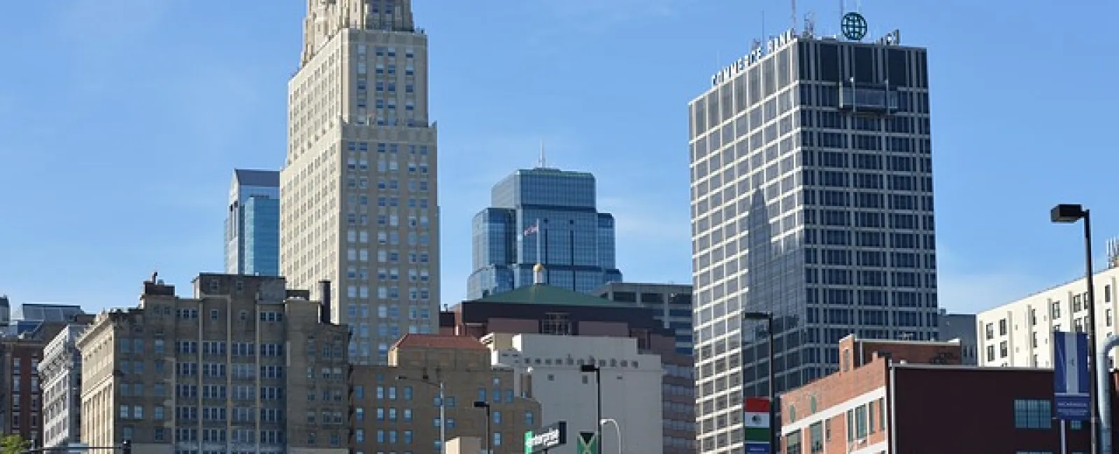 Downtown cityscape with tall office buildings under clear blue sky during daytime