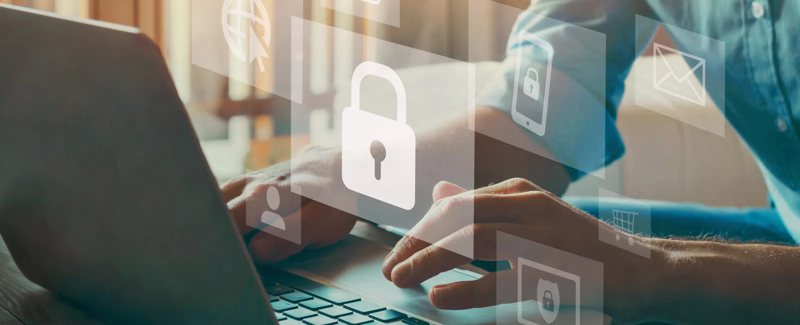 Person using laptop with digital security icons floating, emphasizing online privacy and cybersecurity.