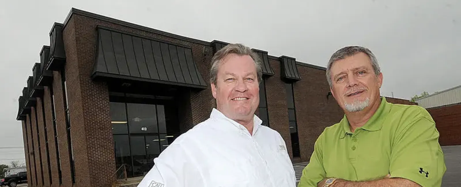 a couple of men posing for the camera