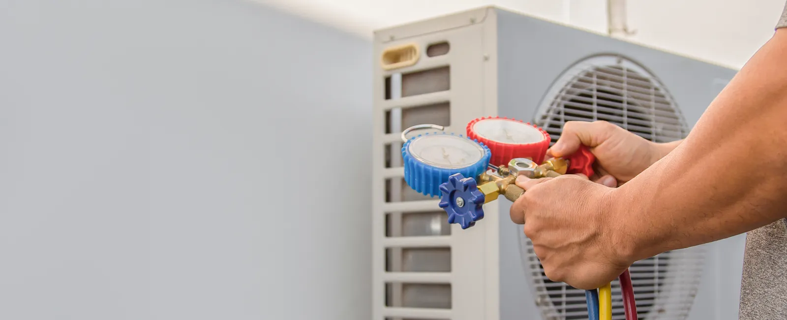Technician checking refrigerant levels of air conditioning unit