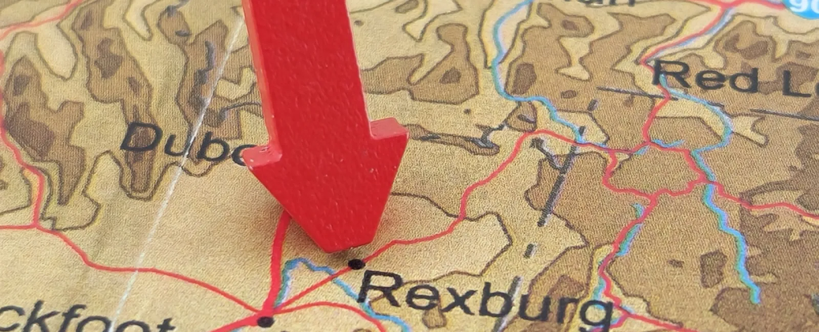 Red arrow pointing at Rexburg on a detailed map showing Idaho Falls, Pocatello, Bozeman and surrounding areas.
