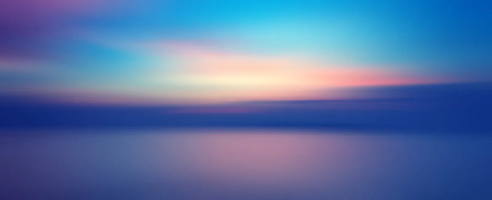 Smooth gradient of blue, purple, and pink hues creating a peaceful abstract sky and water scene.