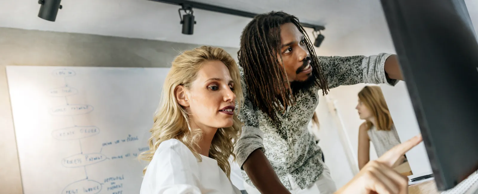 a woman and a man working together in a room