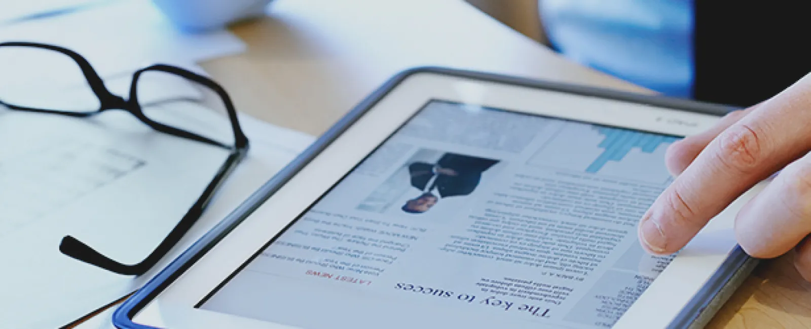 he uses a tablet to learn how to succeed with the  donor impact report of his nonprofit organization