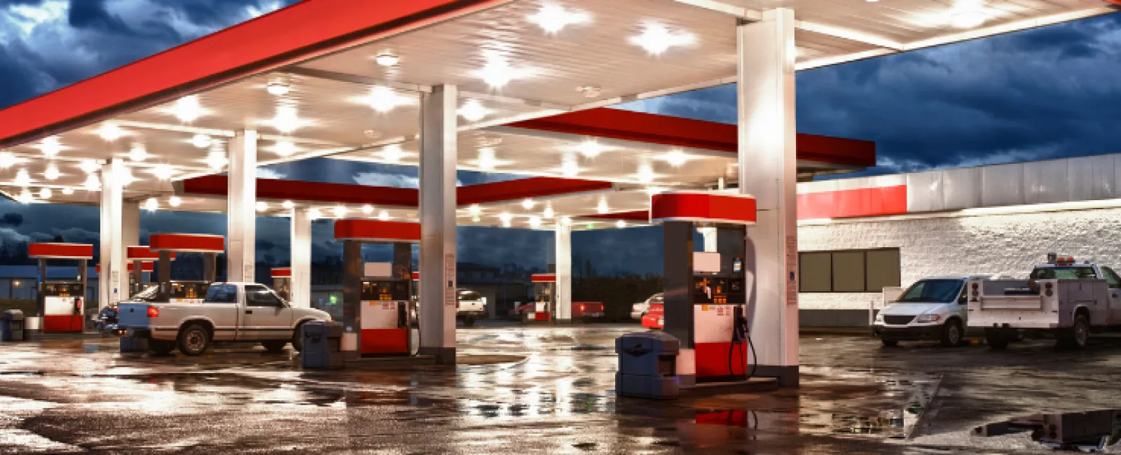 a gas station with cars parked