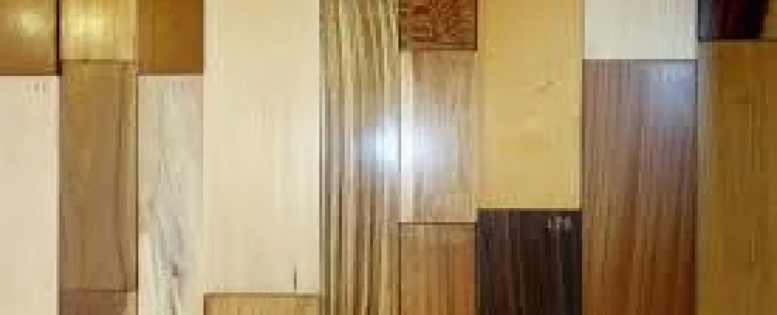 Variety of wooden planks with different grains, colors, and finishes arranged side by side in a grid.