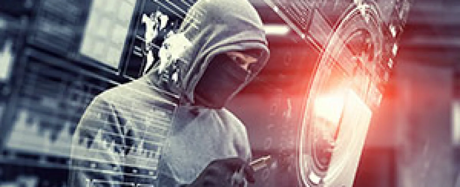 Hacker in hooded sweatshirt using laptop with digital security interface and red light effects