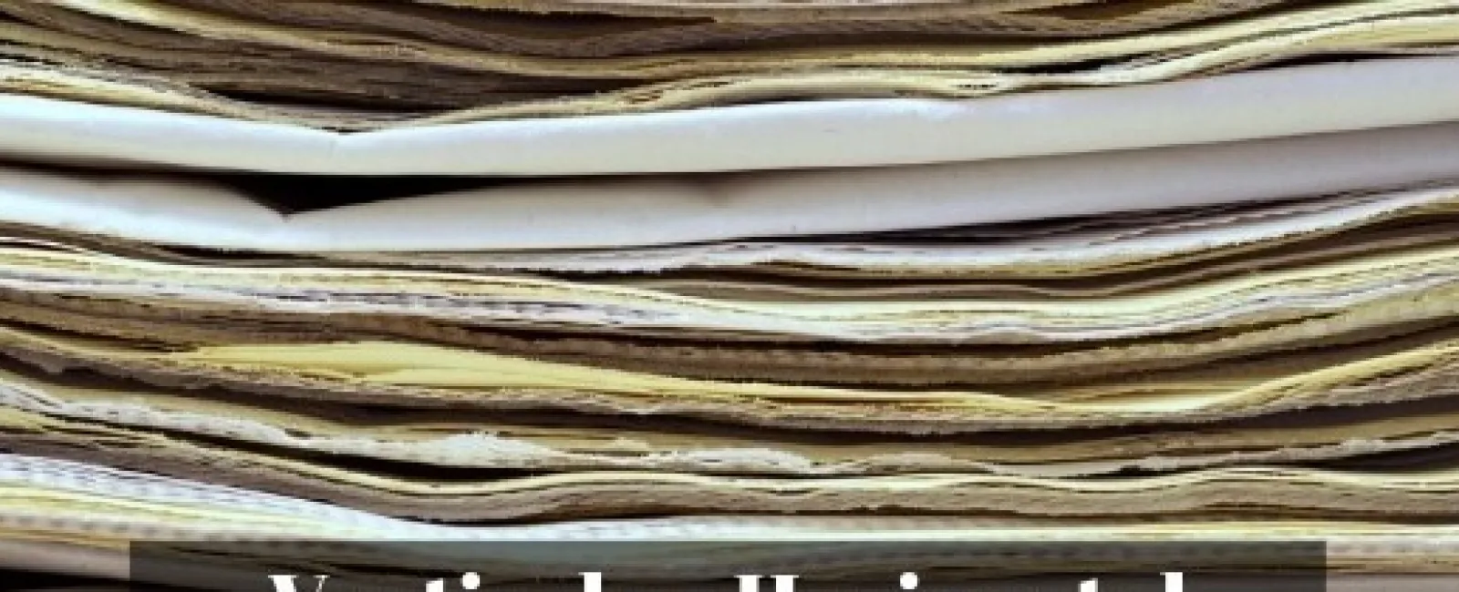 Close-up of a thick stack of worn, uneven old papers or documents piled horizontally.