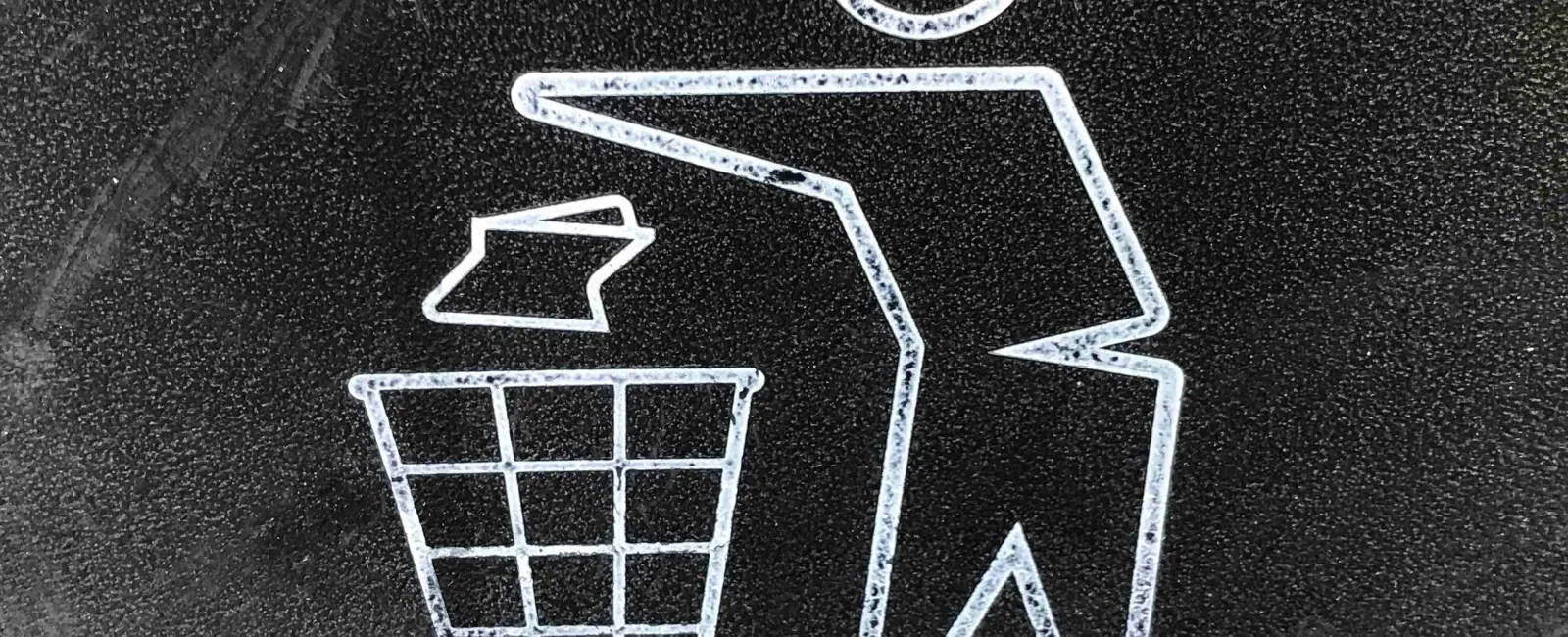 White icon of a person throwing trash into a wireframe waste bin on a black textured background