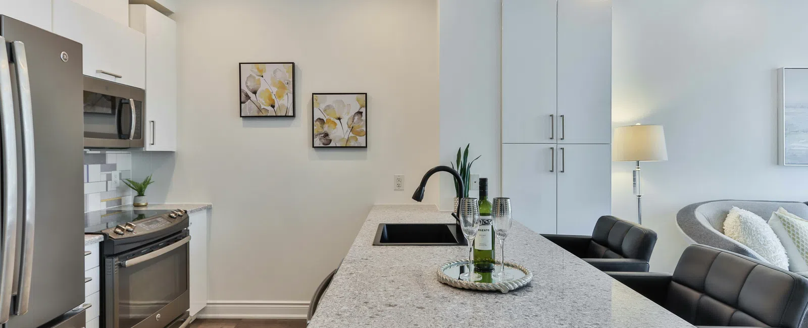 Modern kitchen with stylish cabinetry, granite countertops, and elegant decor, creating a cozy atmosphere.