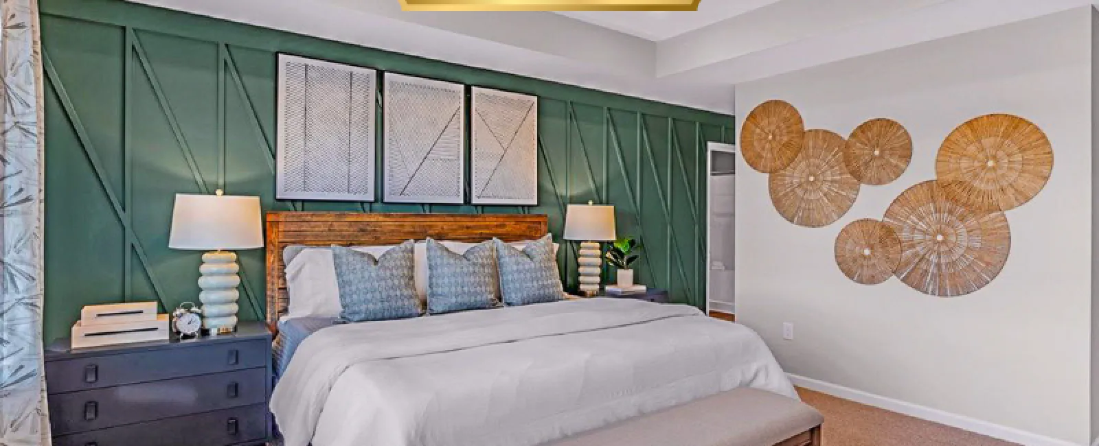 Modern bedroom with green accent wall, wooden bedframe, white bedding, decorative wall art, and bedside lamps