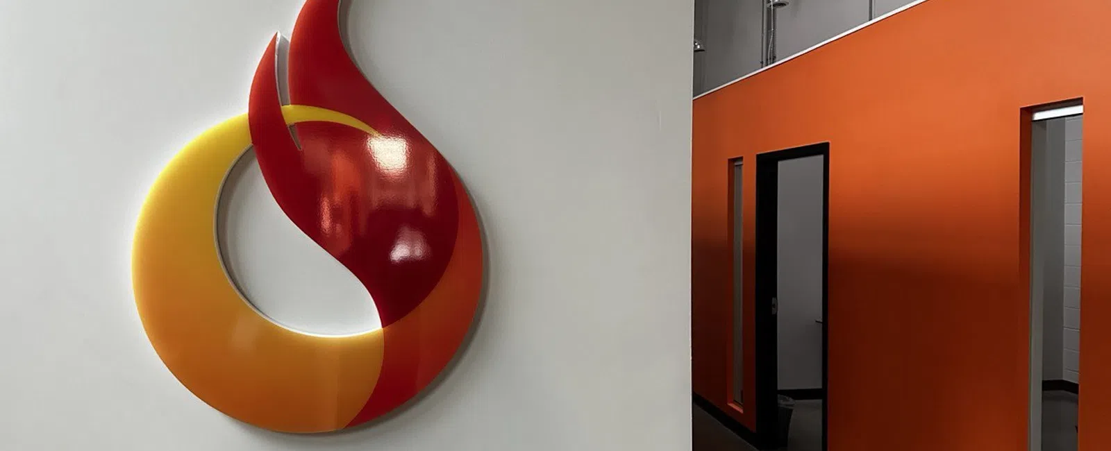 Modern office interior with the red and yellow Octane flame logo on white wall..
