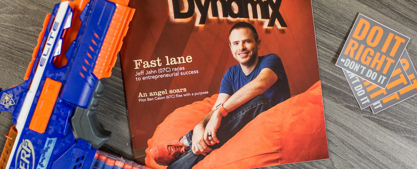 Berry magazine featuring DynamiX with Jeff Jahn on the cover, and motivational posters on wooden surface.