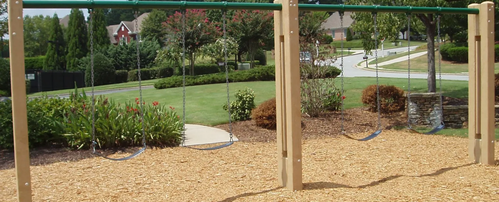 a backyard with trees and a swing set