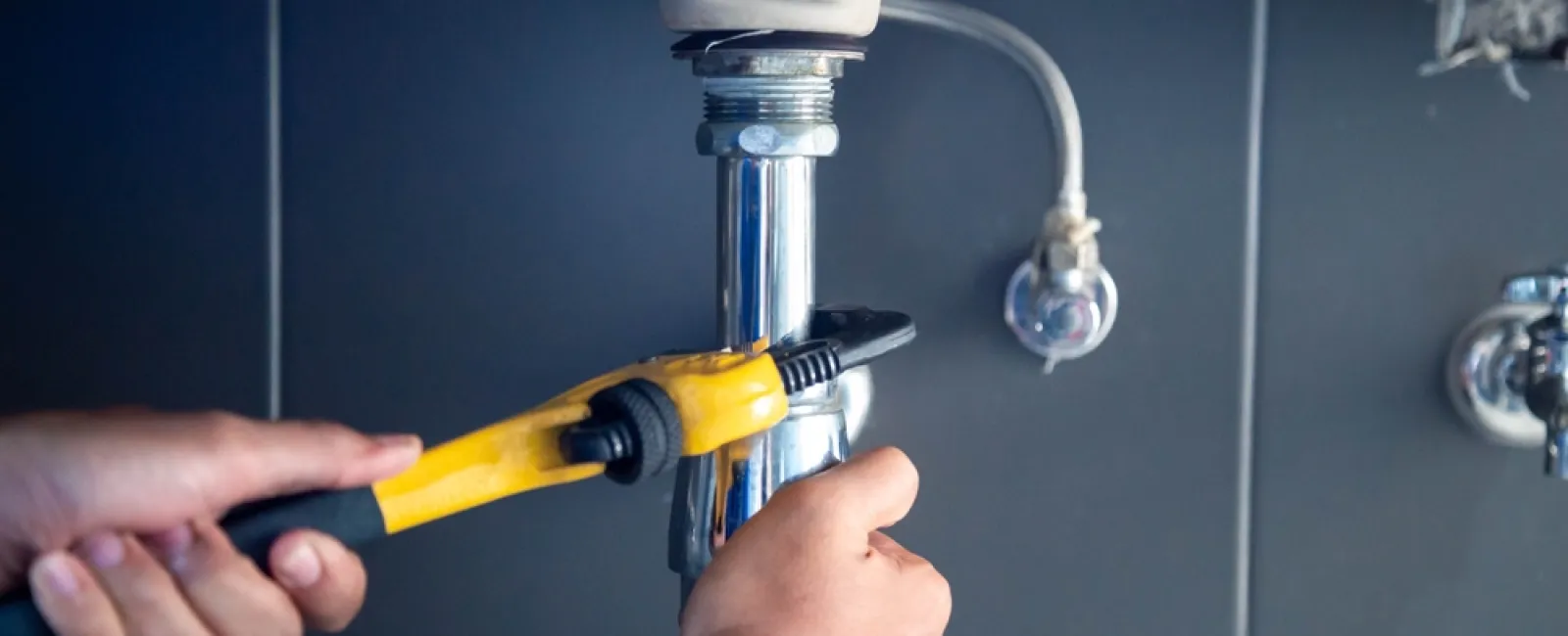 a person holding a yellow drill