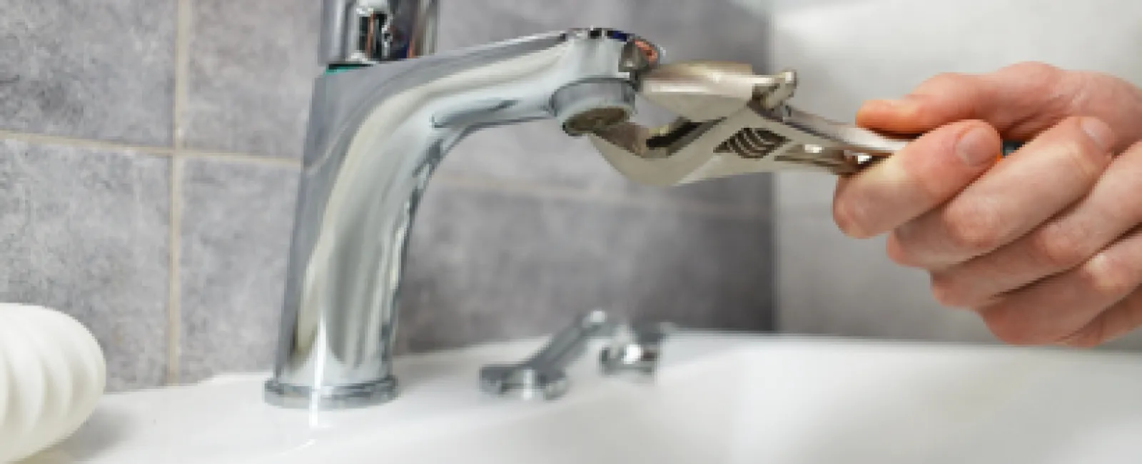 a person washing their hands in a sink