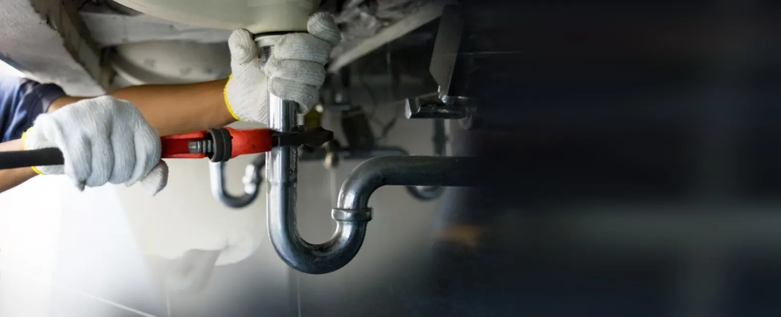 a person wearing gloves and a white lab coat holding a pipe