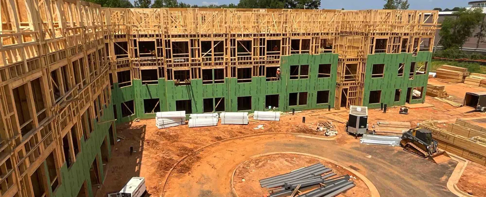 a construction site with a building in the background