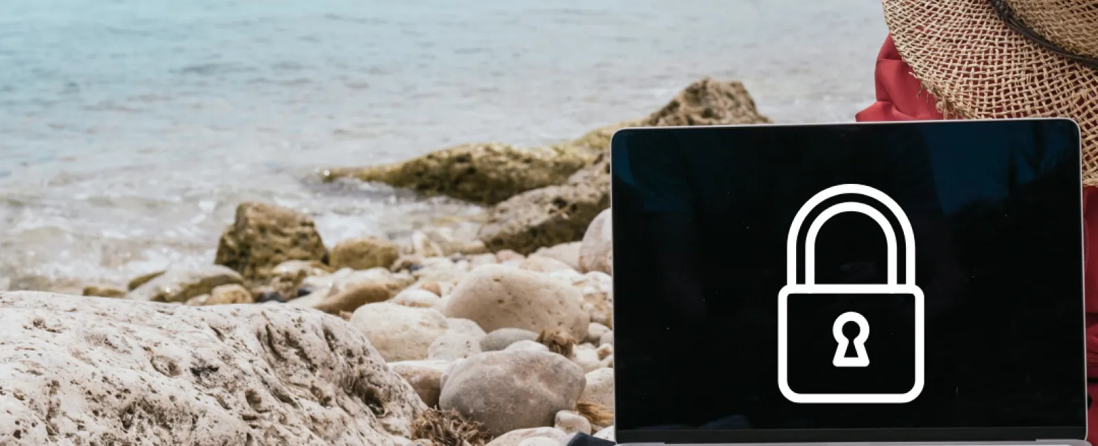 a laptop on a rocky beach