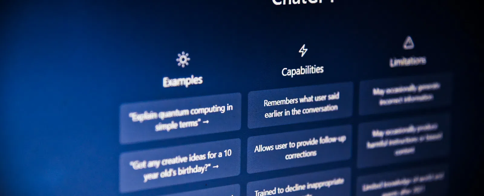 ChatGPT interface showing examples, capabilities, and limitations on a dark blue screen.
