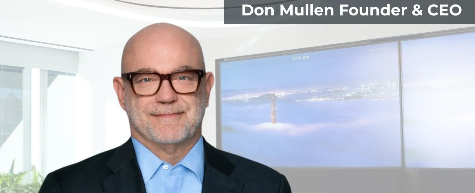 Portrait of Don Mullen, Founder & CEO of Pretium, in office with digital screens and company logo.