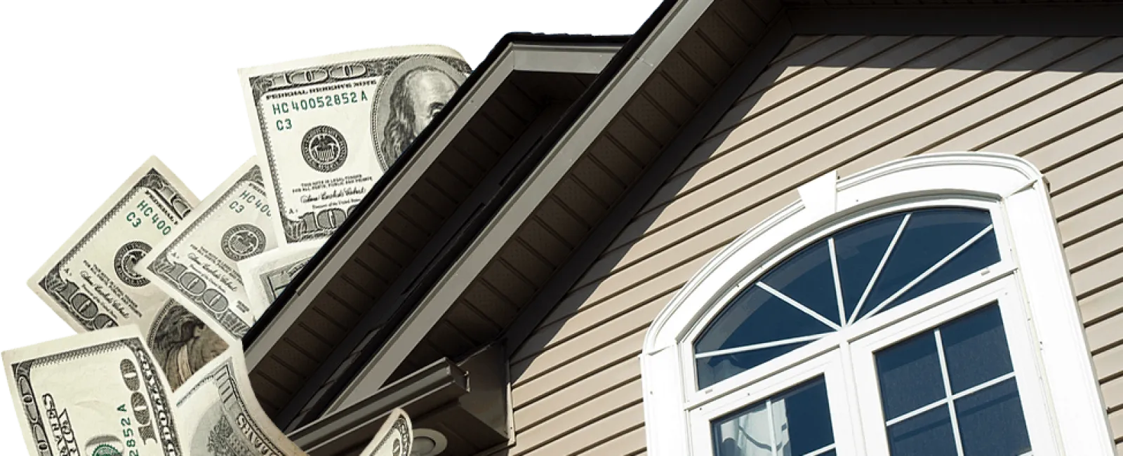 Close-up of house exterior with window and hundred-dollar bills flying behind the roof.
