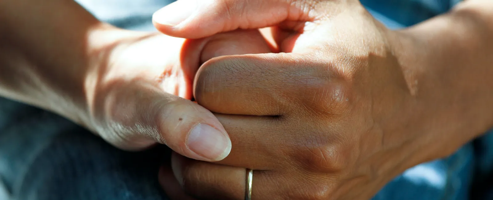 a close-up of a person's hand holding another hand