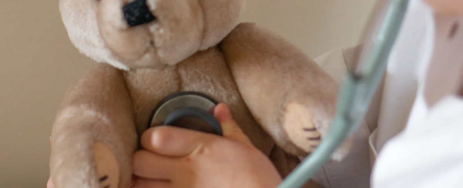 a doctor examining a teddy bear