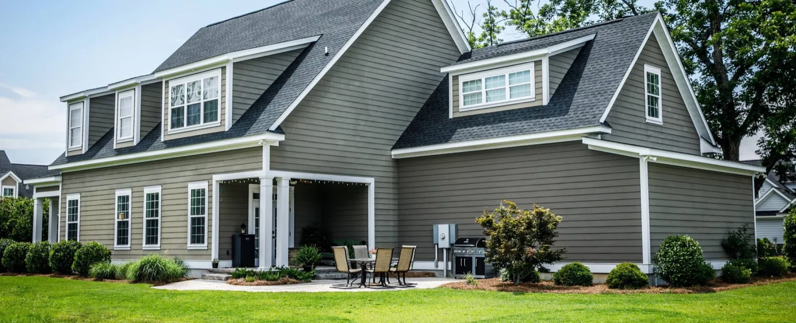 a house with a lawn and chairs