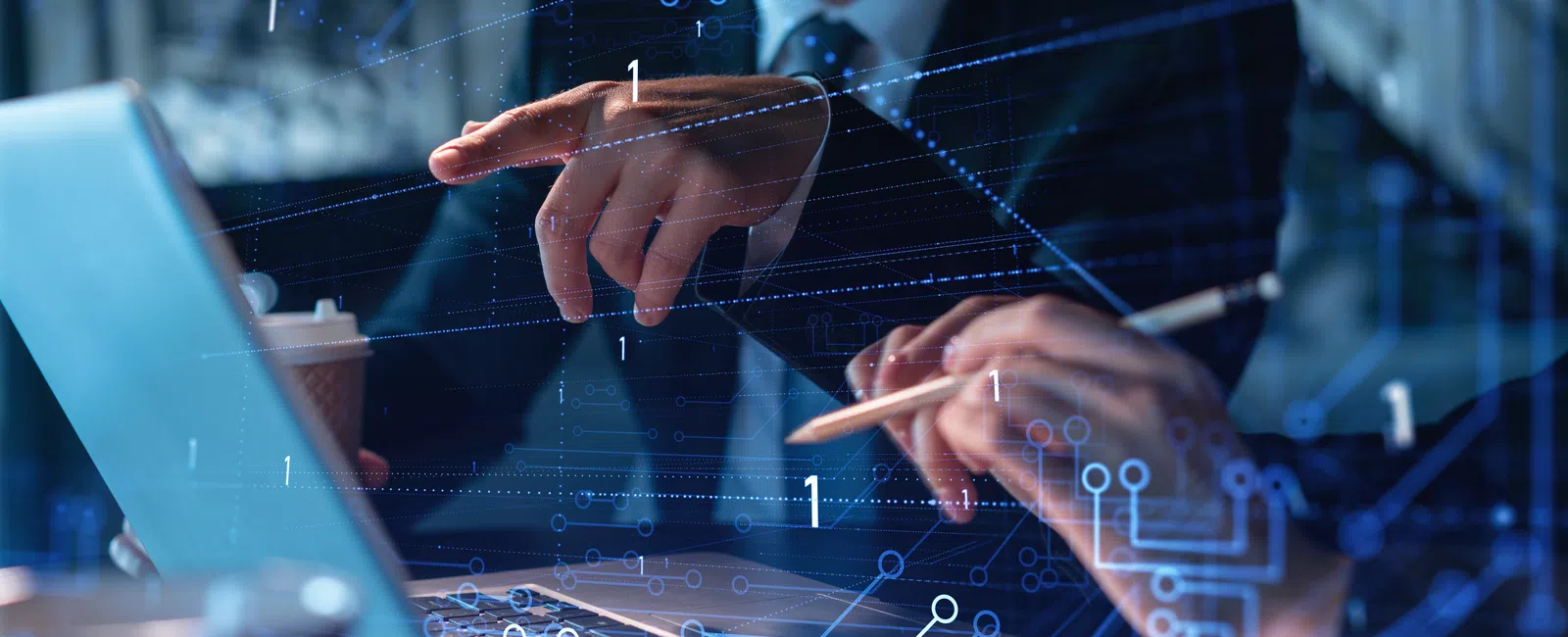 Business professionals analyzing data and digital circuits on a laptop in a modern office setting.
