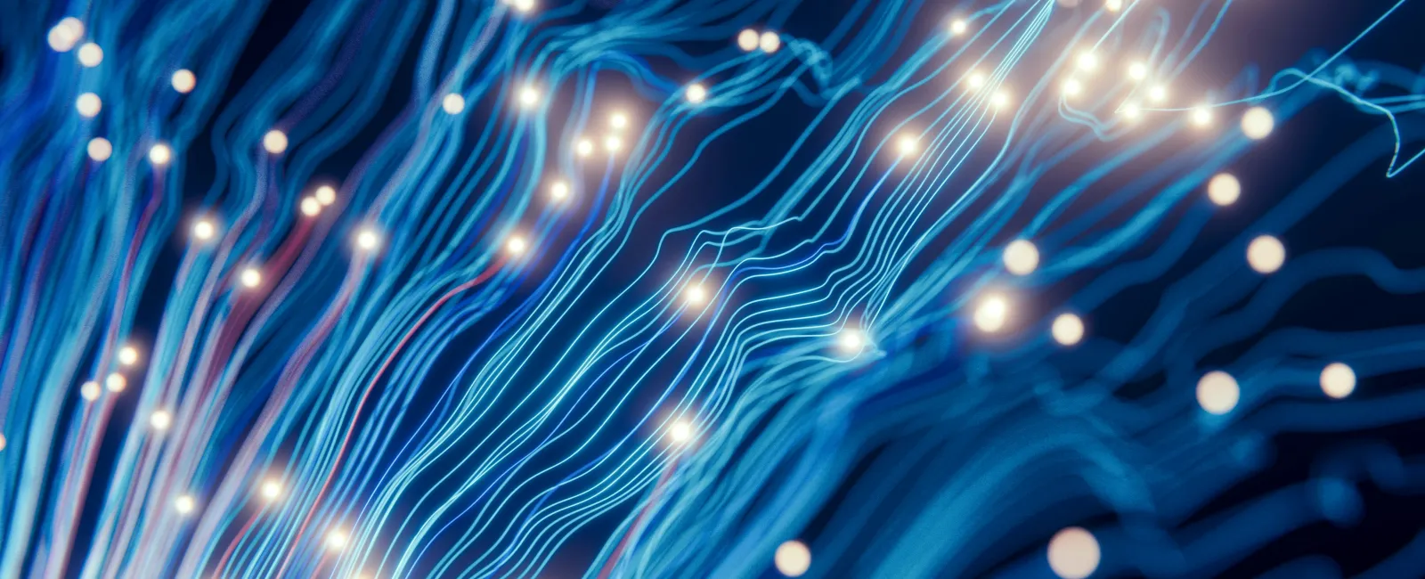 Glowing blue fiber optic cables with bright light points representing data transmission and connectivity.