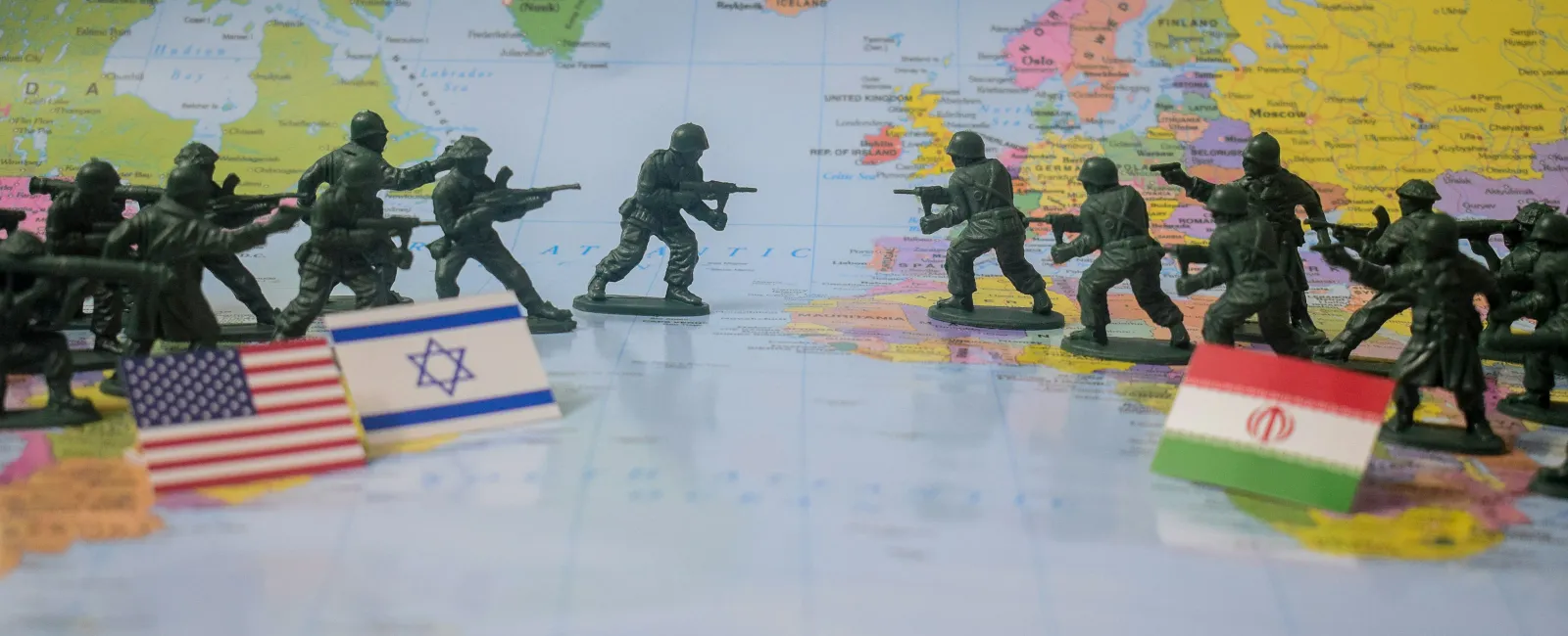 Modern hospital building with glass windows and brick exterior surrounded by trees under a blue sky.