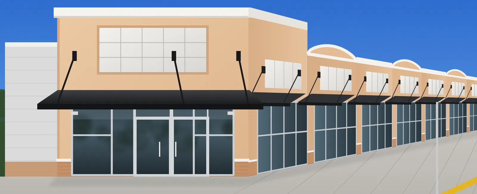 Modern shopping center exterior with large glass windows and black awnings on a clear sunny day