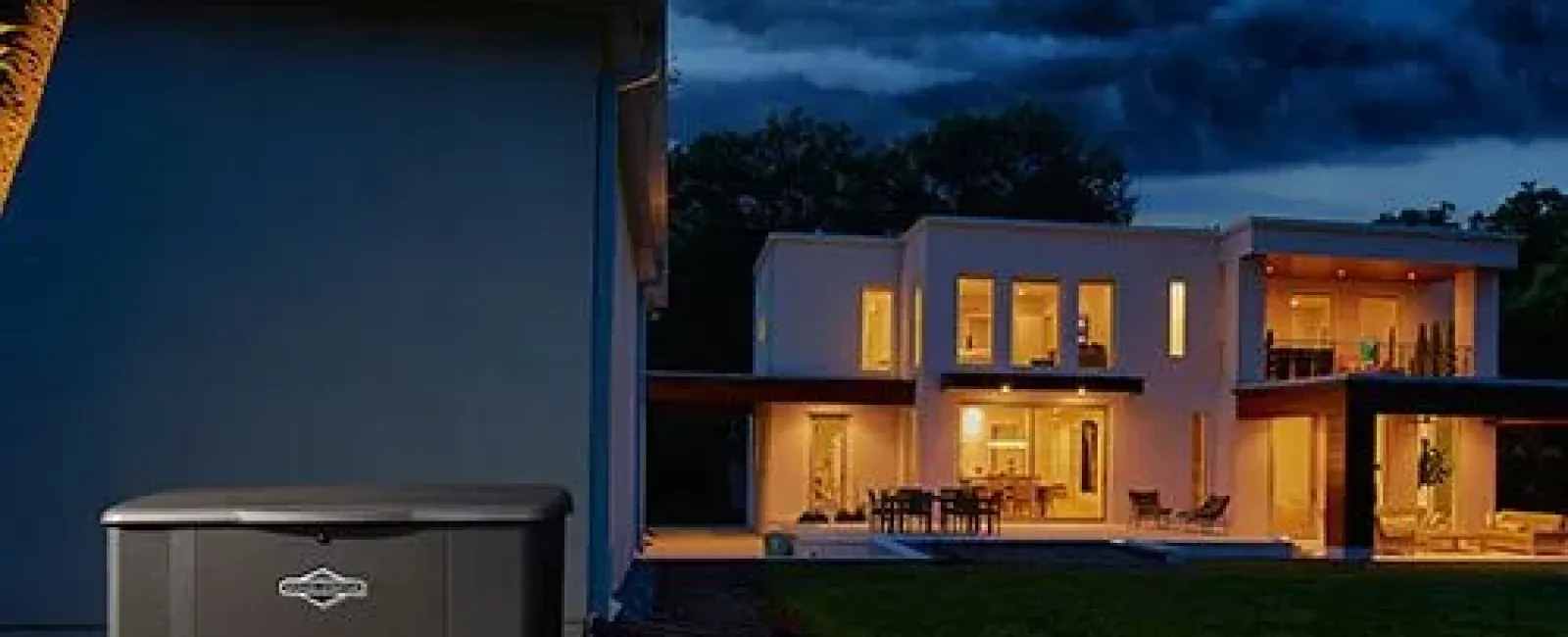 A portable generator peacefully illuminates a modern home at dusk, surrounded by trees.