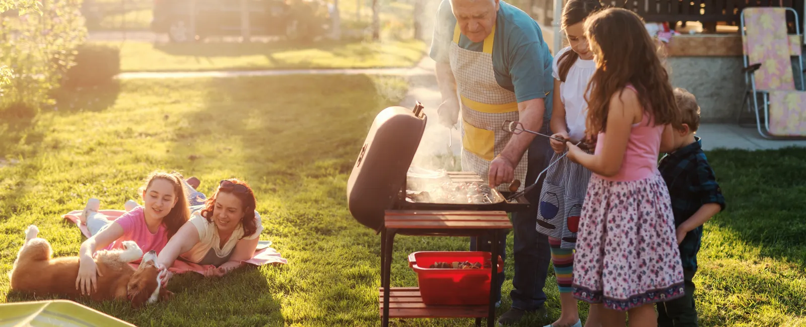 Backyard barbecue with a happy, pest-free family after a completed Greenix service.