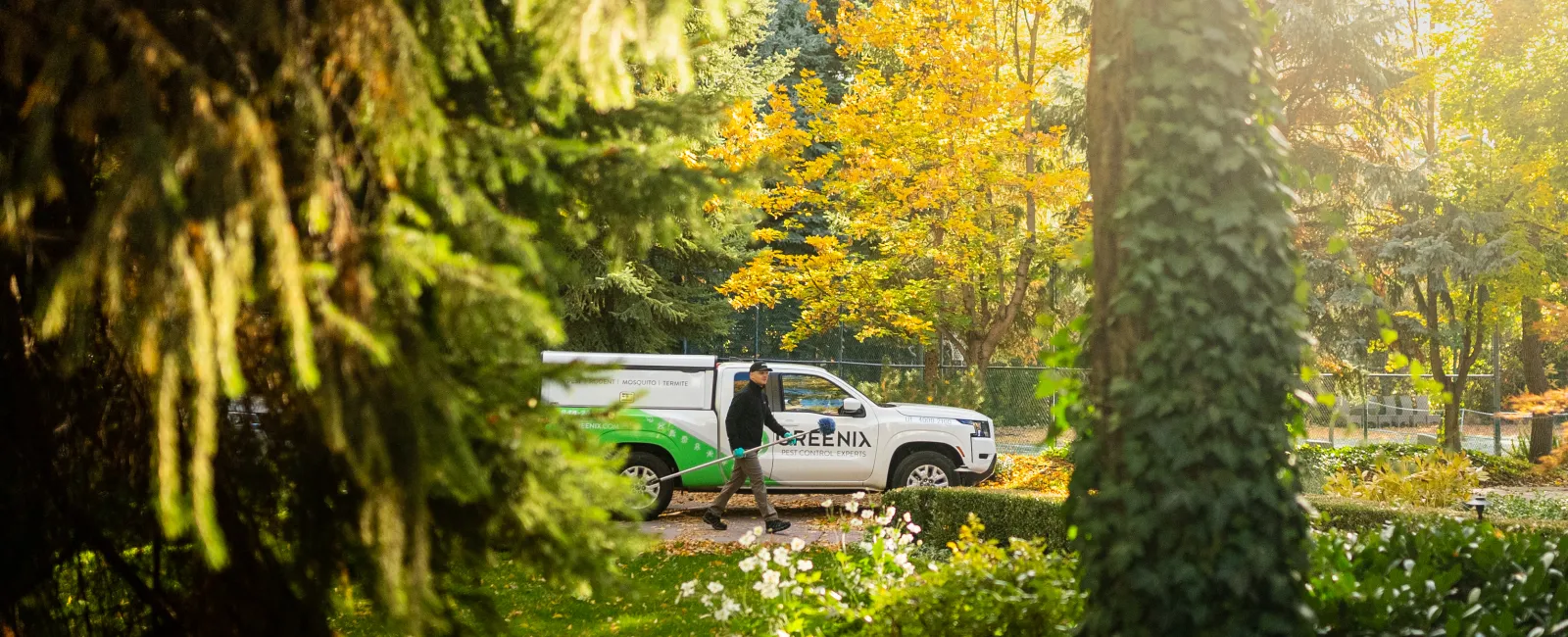 a technician walking next to Greenix truck