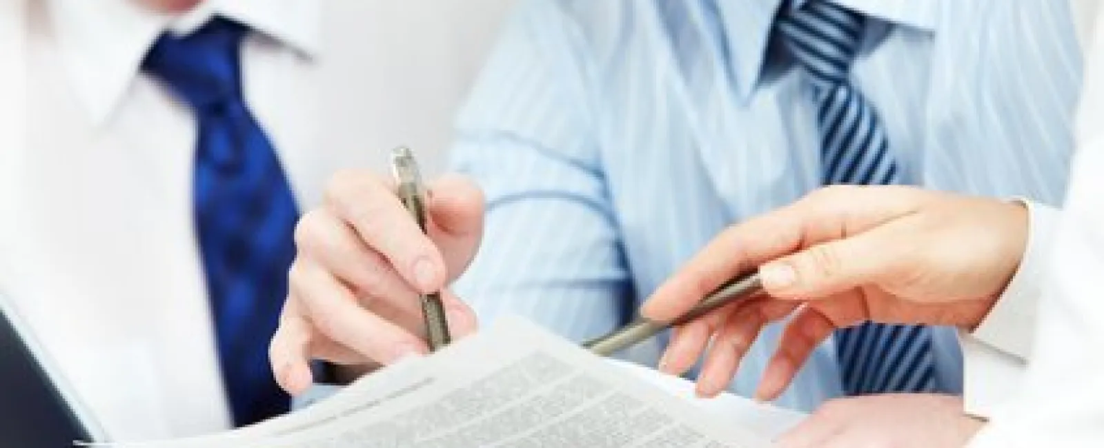 Business professionals reviewing and discussing documents together in a meeting.