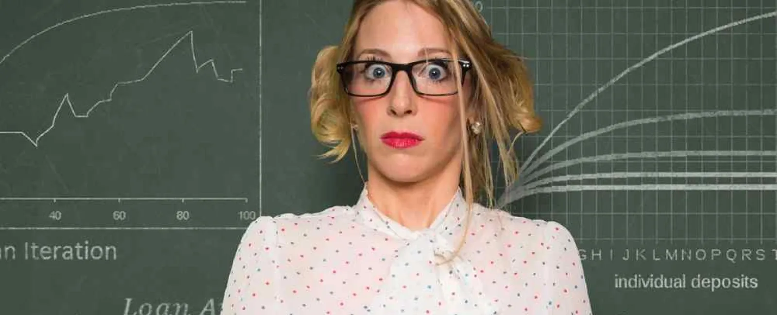 Woman with glasses looking surprised while reading a How To book against a chalkboard with financial graphs.