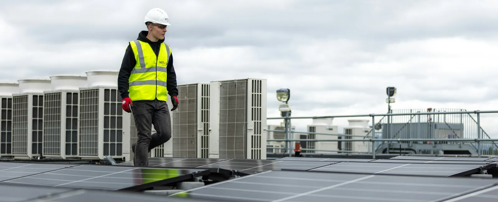 HVAC technicians in safety vests inspecting rooftop units at a Snellville GA building