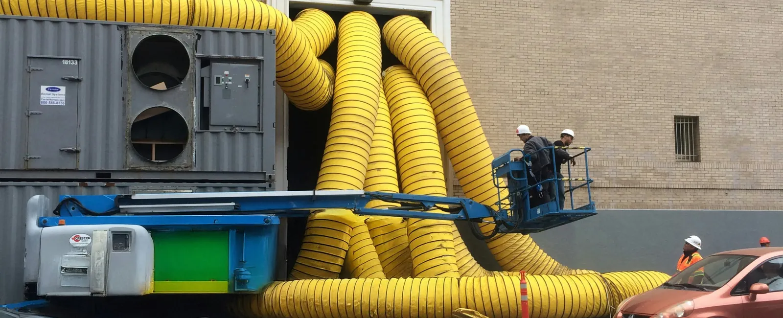 Professional duct cleaning truck servicing a Monroe GA home with yellow vacuum hoses