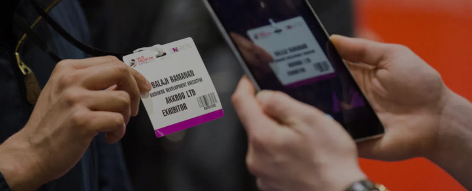 Exhibitor scanning an attendee badge with a handheld lead capture device at a trade show