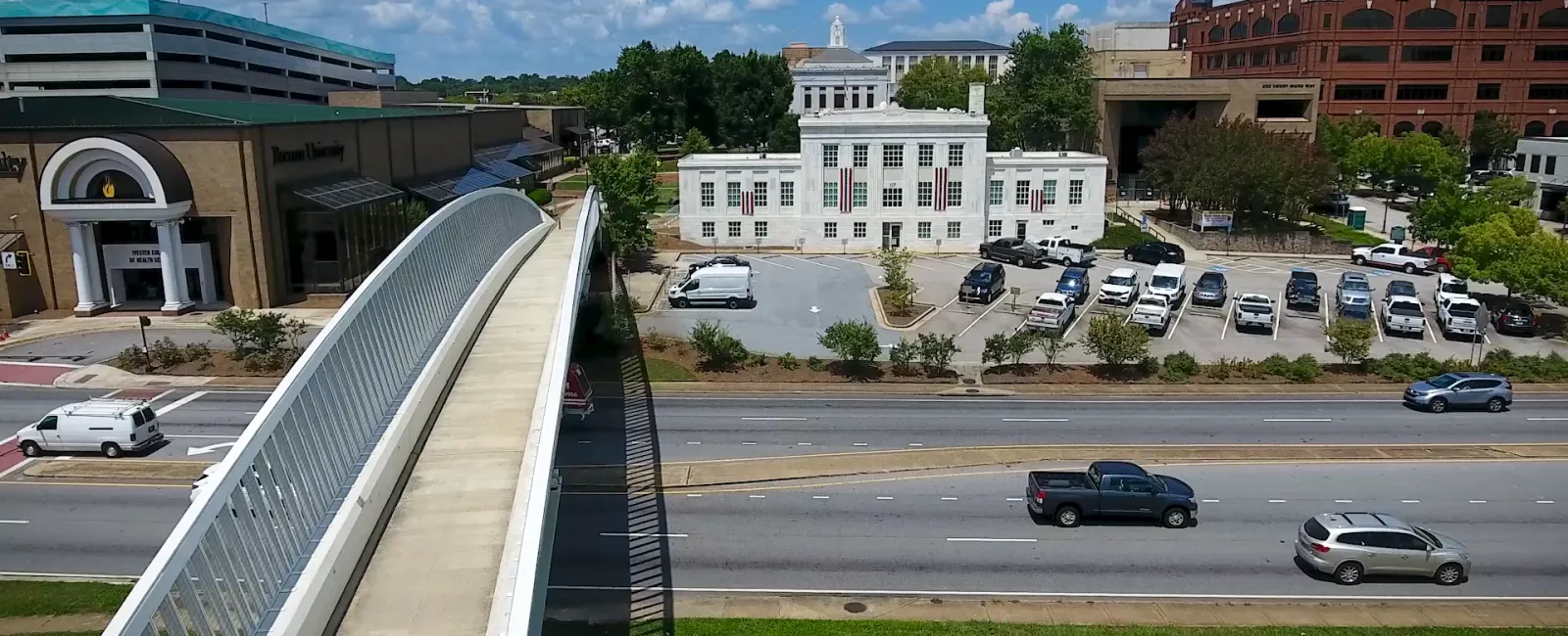 a parking lot with cars and buildings