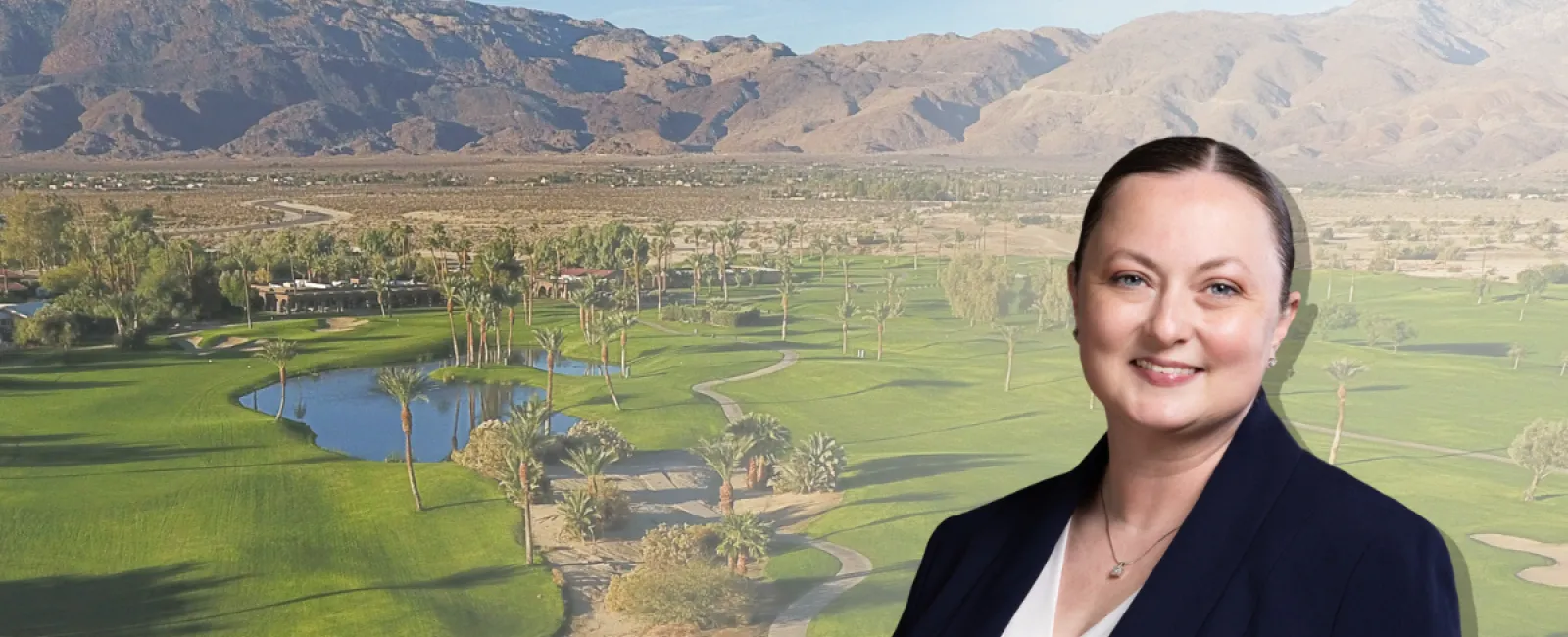 Professional woman smiling in business suit with golf course and mountains background